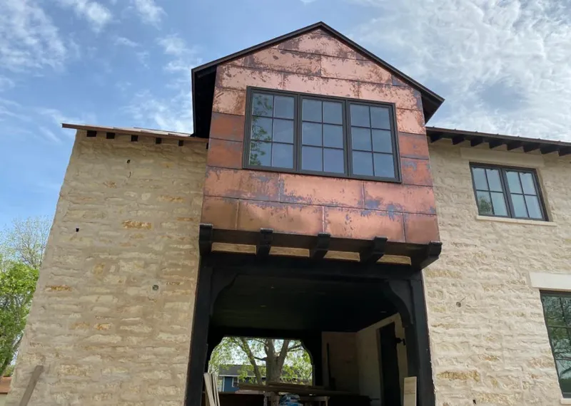 Copper metal panel facade on a stone building for Metal Roof Coating in Woodmoor