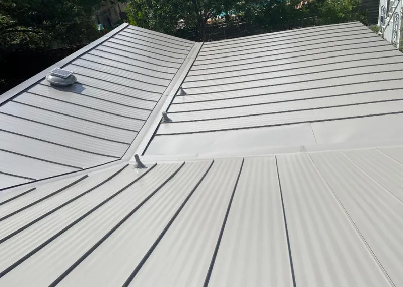 Solar attic fan installed on a metal roof for Roof Ventilation in Woodmoor